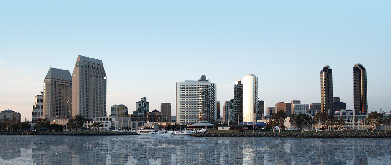San Diego skyline reflected on water at dusk.